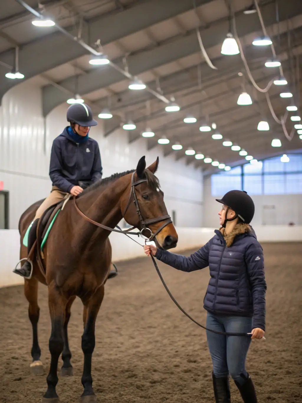 A photograph of a TEV instructor providing personalized guidance to a rider in a training session, showcasing the camp's commitment to individual attention and skill development.
